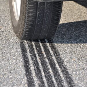 Car braking on road leaving tread marks