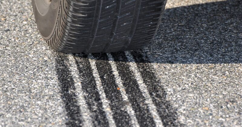 Car braking on road leaving tread marks